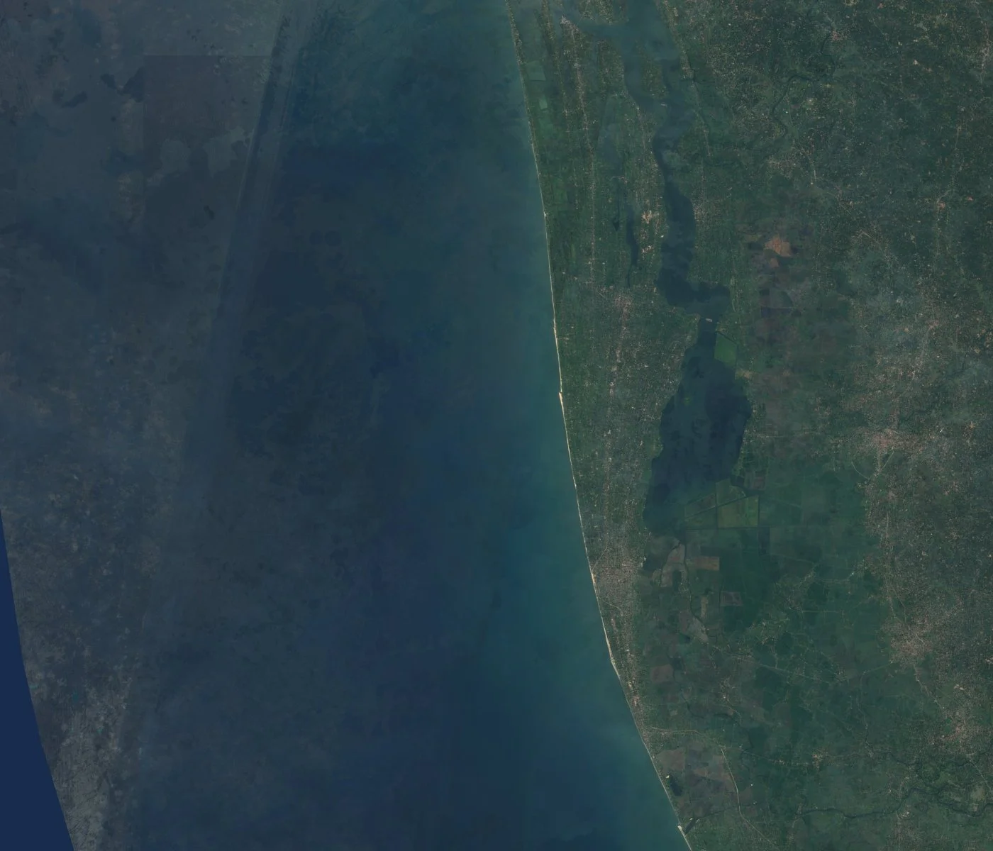 Satellite image of the Kerala backwaters and southern coast of India, showing Vembanad Lake and coastal farmland