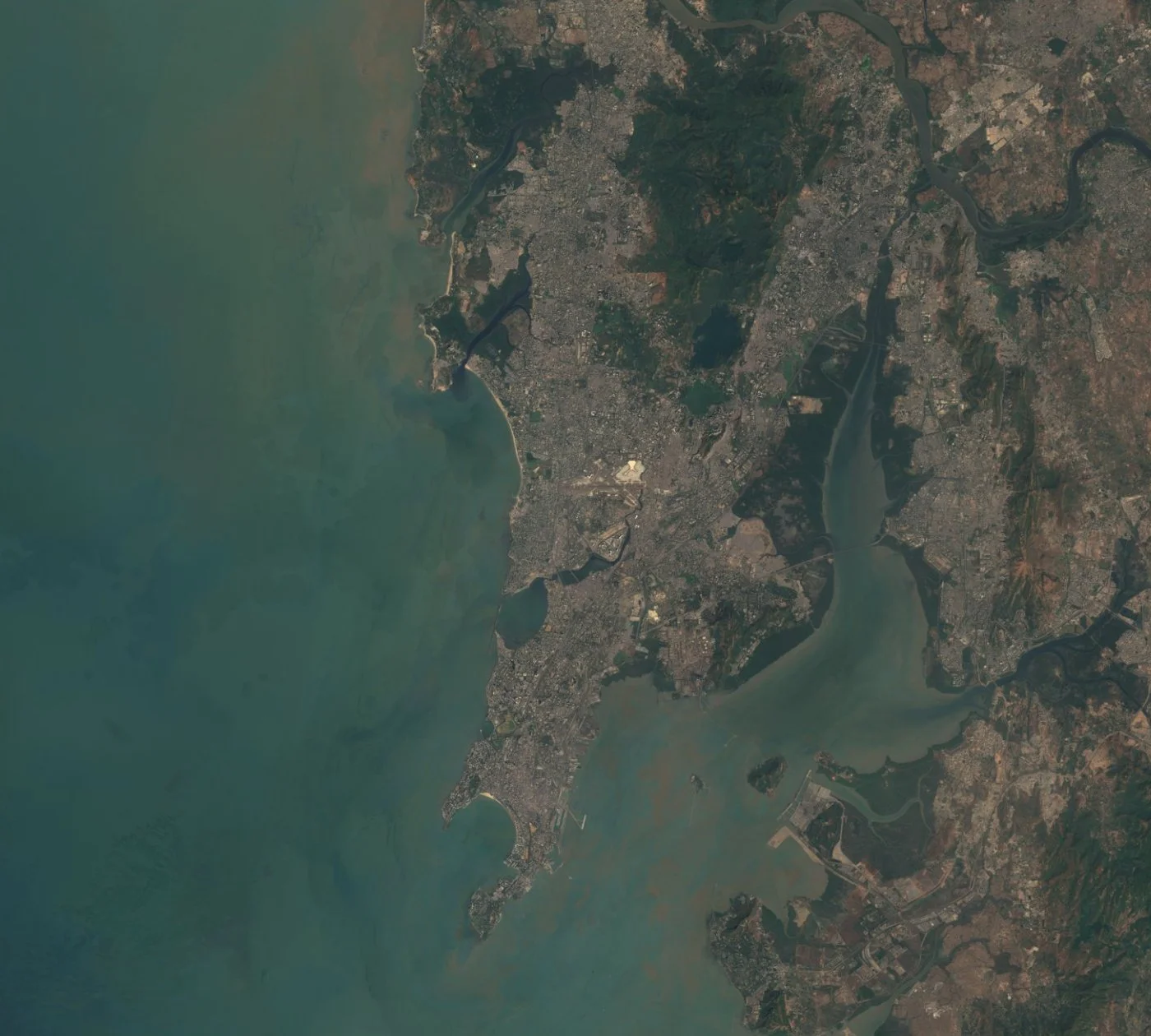 Satellite image of Mumbai and the western coast of India, showing the city peninsula, Thane Creek, and the Arabian Sea coastline