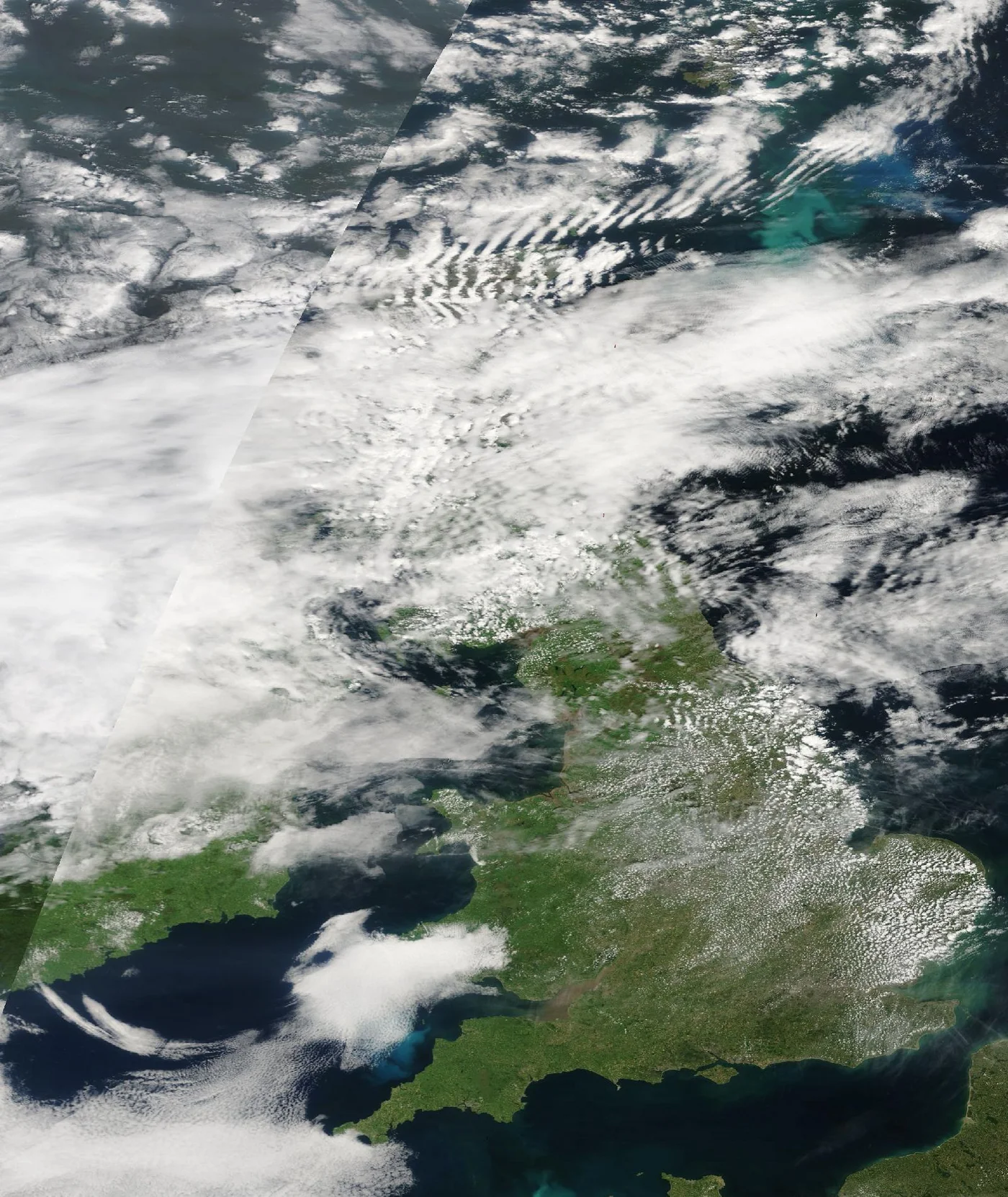 Satellite image of the UK partly obscured by cloud, captured by NASA Terra MODIS on June 18, 2025