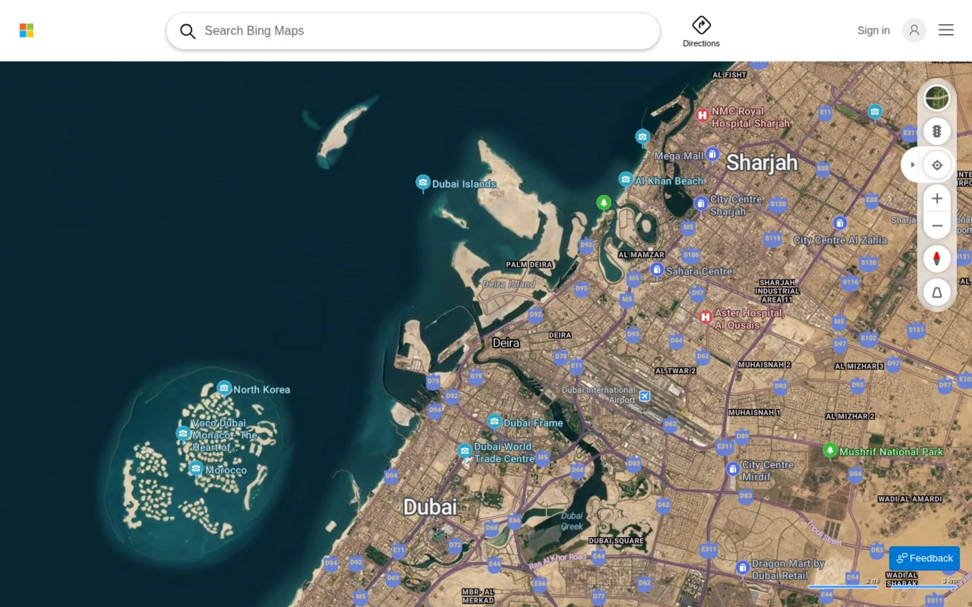 Bing Maps aerial hybrid satellite view over Dubai and Sharjah, showing labeled roads and points of interest
