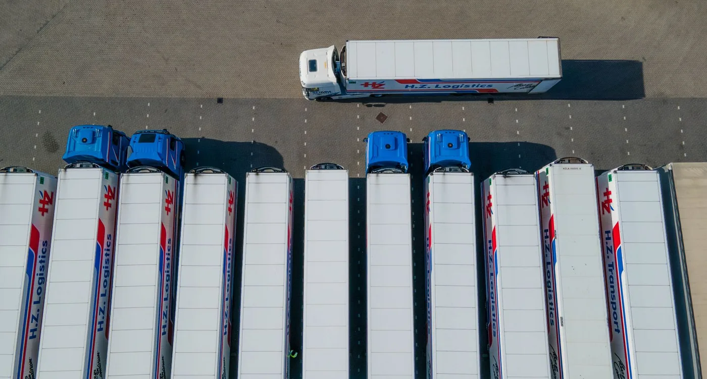 Sub-meter satellite imagery with AI detection boxes identifying individual vehicles and equipment at an oil and gas site