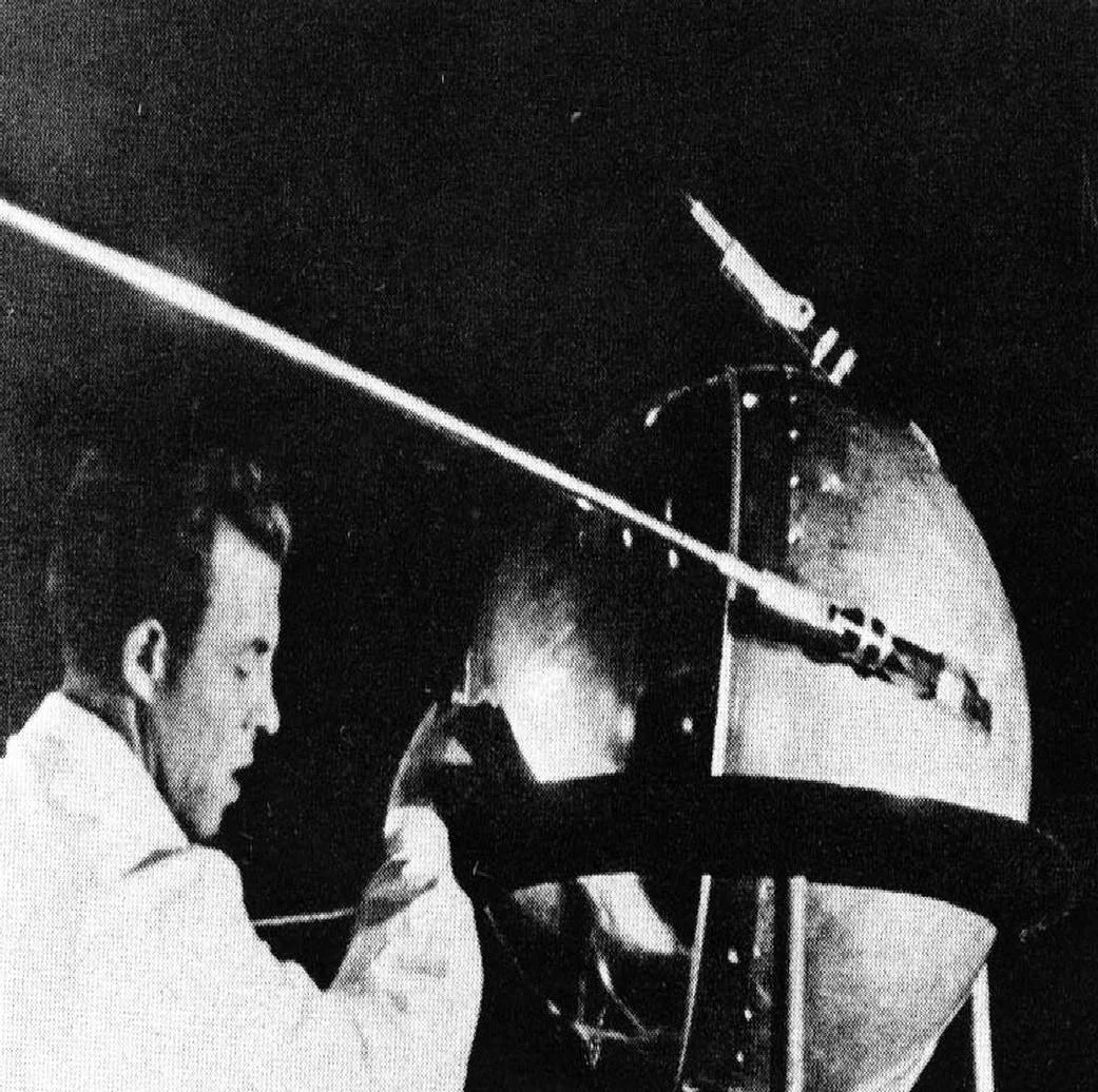 A technician putting the finishing touches on Sputnik 1, the first artificial satellite, which carried no camera and captured no satellite imagery