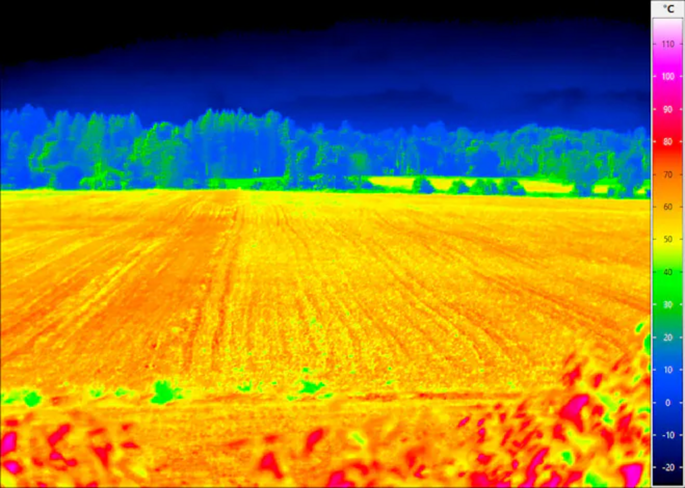 Thermal heat map of a farm field showing surface temperature variation in a blue-to-orange-to-magenta gradient